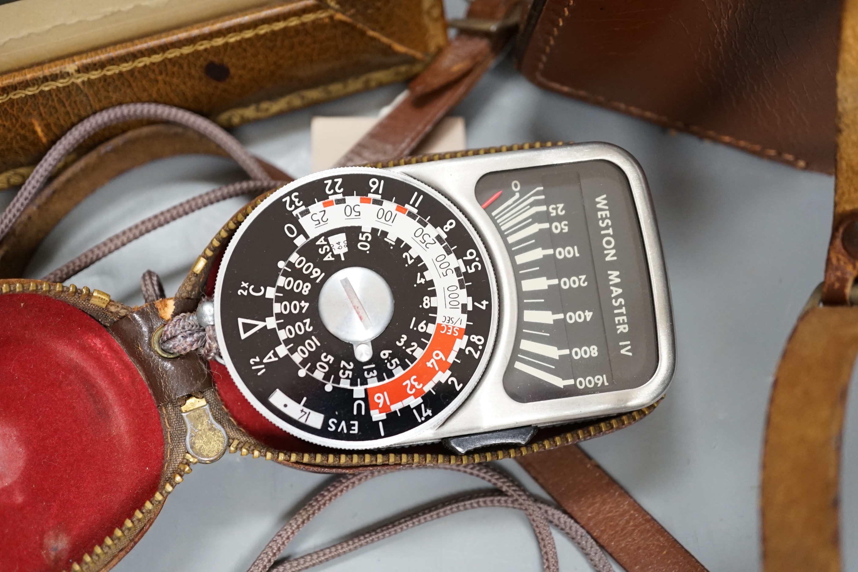 A Rolleicord TLR camera model Va, serial no. 1942058, with a Weston Master IV universal exposure meter and a Harrod's leather photo frame